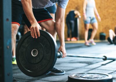 Focused weightlifting session in a gym with diverse athletes participating indoors.